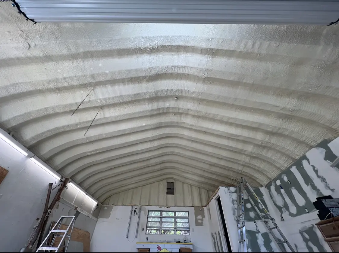 Spray polyurethane foam applied to the underside of a metal roof deck in Imperial